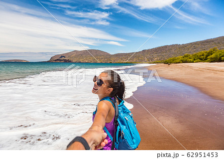 Galapagos tourists having fun on travel on Espumilla Beach, Santiago, Galapagos Galapagos tourists having fun on travel on Espumilla Beach, Santiago, Galapagos 62951453