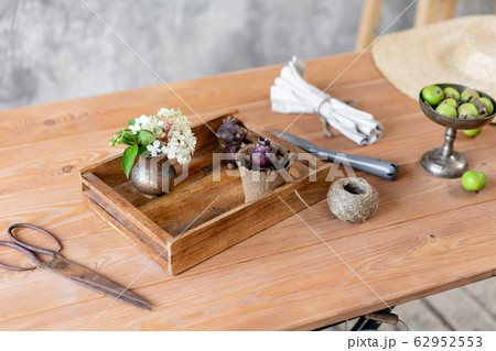 Set of gardener transplanting bulbous plants, hyacinths in cement pots on the wooden table. Concept of home garden. Flower and garden shop. Set of gardener transplanting bulbous plants, hyacinths in cement pots on the wooden table. Concept of home garden. Flower and garden shop. 62952553