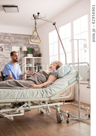 Friendly male nurse talking with senior woman 62956901
