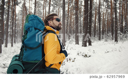 Hiking traveler enjoying winter forest Hiking traveler enjoying winter forest 62957969