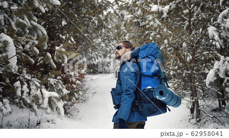 Hiker enjoying winter forest Hiker enjoying winter forest 62958041