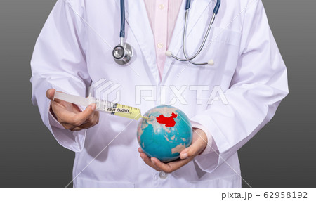 doctor in medical gown using an antiviral vaccine syringe on the red China map on the globe in hand. outbreak situation of Coronavirus 2019 infection or Covid-19 doctor in medical gown using an antiviral vaccine syringe on the red China map on the globe in hand. outbreak situation of Coronavirus 2019 infection or Covid-19 62958192