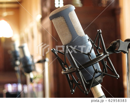 Close up of retro vintage microphone against with blur background Close up of retro vintage microphone against with blur background 62958383