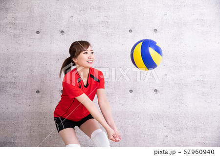 バレーボールをやる女性(笑顔でレシーブ) バレーボールをやる女性(笑顔でレシーブ) 62960940