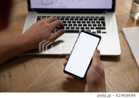 Caucasian man using a smartphone 62968699