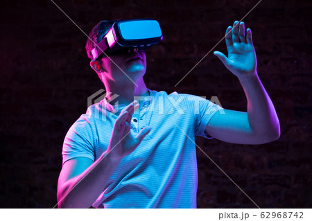 Caucasian man holding a Virtual Reality headset Caucasian man holding a Virtual Reality headset 62968742