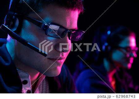 Caucasian man and a woman working late in an office Caucasian man and a woman working late in an office 62968743