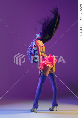 Attractive hawaiian brunette model on purple studio background in neon light Attractive hawaiian brunette model on purple studio background in neon light 62970004