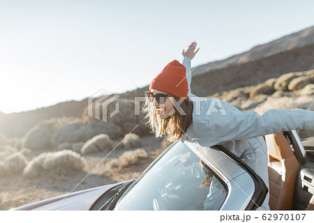 Happy woman traveling by car 62970107