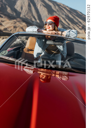 Carefree woman traveling by car Carefree woman traveling by car 62970132
