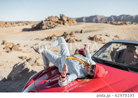 Carefree woman traveling by car 62970195