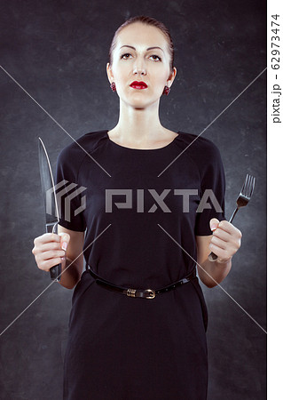 Portrait of a beautiful young woman with a knife 62973474
