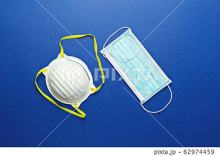 Two types of protective face masks on blue 62974459