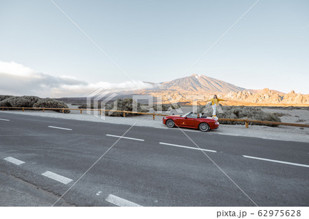 Woman traveling by car on the volcanic valley Woman traveling by car on the volcanic valley 62975628