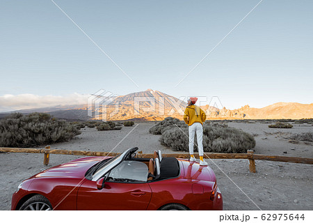 Woman traveling by car on the volcanic valley Woman traveling by car on the volcanic valley 62975644
