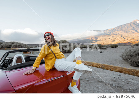 Portrait of a joyful woman enjoying road trip in nature 62975646