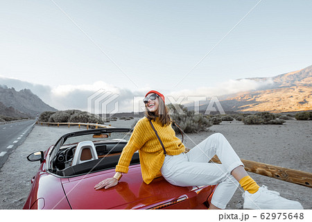 Portrait of a joyful woman enjoying road trip in nature 62975648