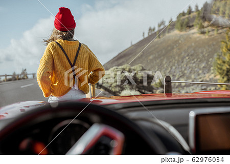 Woman tarveling by car on the mountain road Woman tarveling by car on the mountain road 62976034