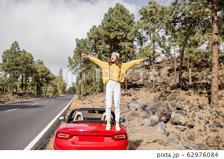 Woman traveling by car in the mountain forest 62976084