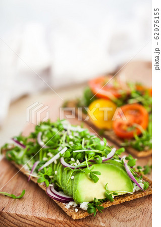 Avocado rye toasts with green herbs, onion and Avocado rye toasts with green herbs, onion and 62976155