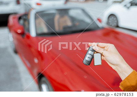 Woman holding keychain at the car parking Woman holding keychain at the car parking 62978153