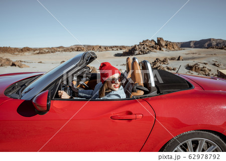 Woman traveling by cabriolet car on the desert velley Woman traveling by cabriolet car on the desert velley 62978792