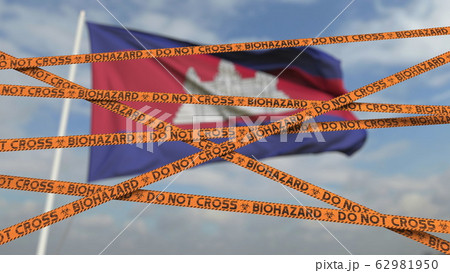 Biohazard restriction tape lines against the Cambodian flag. Restricted entry or quarantine in Cambodia. Conceptual 3D rendering Biohazard restriction tape lines against the Cambodian flag. Restricted entry or quarantine in Cambodia. Conceptual 3D rendering 62981950