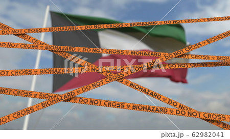 Biohazard restriction tape lines against the Kuwaiti flag. Restricted border crossing or quarantine in Kuwait. Conceptual 3D rendering Biohazard restriction tape lines against the Kuwaiti flag. Restricted border crossing or quarantine in Kuwait. Conceptual 3D rendering 62982041