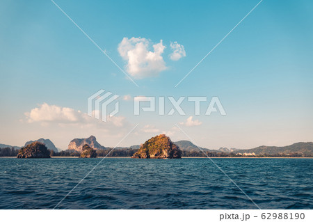 Blue sea and rocky mountains, evening bay in Krabi Blue sea and rocky mountains, evening bay in Krabi 62988190