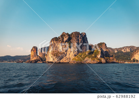 Blue sea and rocky mountains, evening bay in Krabi Blue sea and rocky mountains, evening bay in Krabi 62988192