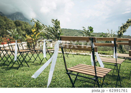 Decorated chairs at a wedding event. Decorated chairs at a wedding event. 62991761