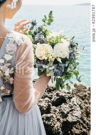 Bride holding a wedding bouquet Bride holding a wedding bouquet 62991787