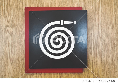 Fire hose sign on wood background Fire hose sign on wood background 62992380