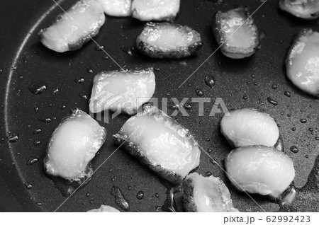 Slices of bacon frying in its own grease on frypan Slices of bacon frying in its own grease on frypan 62992423