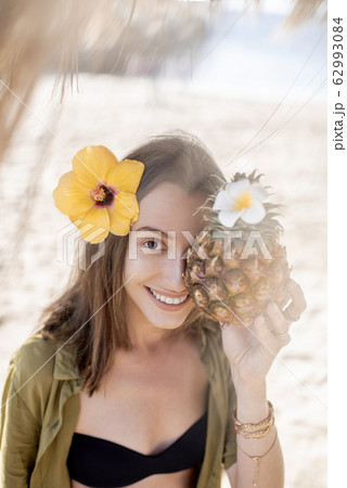 Summer girl with pineapple fruit at the beach resort Summer girl with pineapple fruit at the beach resort 62993084