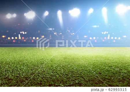 Green grass and tribune with blurred lights 62993315