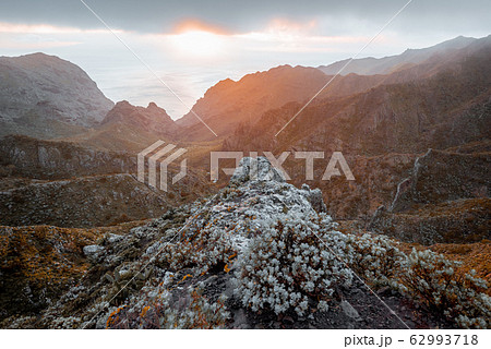 Mountain range under the clouds on a sunset 62993718