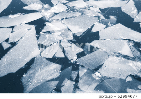 Fragments of melting ice float on a river water 62994077