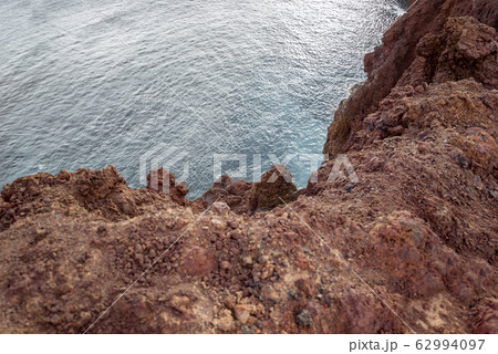 Rocky ocean coast with steep precipice 62994097