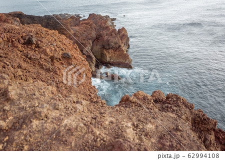 Rocky ocean coast with steep precipice Rocky ocean coast with steep precipice 62994108
