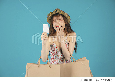 Asian girl carrying shopping bags with summer dress and enjoys shopping.  62994567