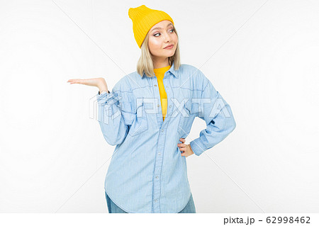 stylish blonde girl in casual look with holding hand with a template on a white background stylish blonde girl in casual look with holding hand with a template on a white background 62998462