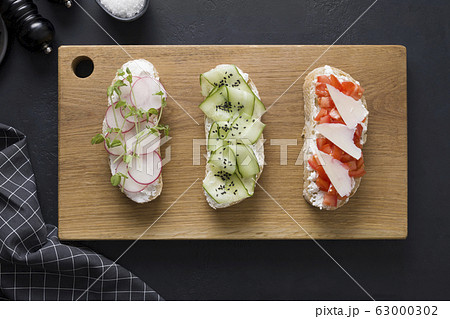 Different sandwiches on toast with vegetables. 63000302