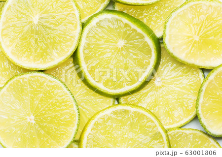 Slices of ripe juicy lime. Green background of 63001806