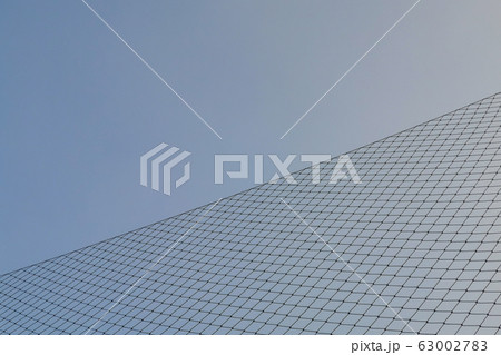 Metal crossed gate against sunlight and blue sky Metal crossed gate against sunlight and blue sky 63002783