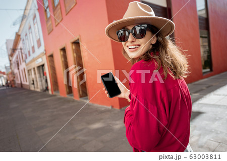 Woman with smart phone on the city street 63003811