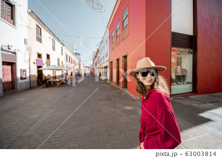 Stylish woman walking the street in the old town 63003814