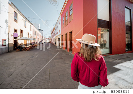 Stylish woman walking the street in the old town 63003815