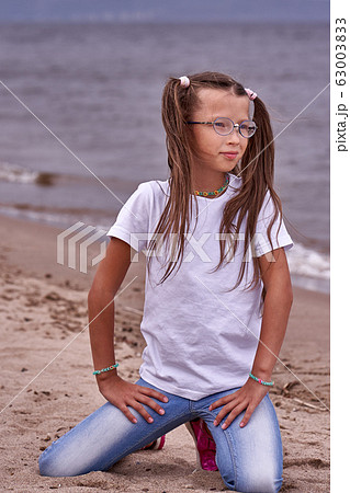 Portrait of a teenage girl in glasses and a white Portrait of a teenage girl in glasses and a white 63003833