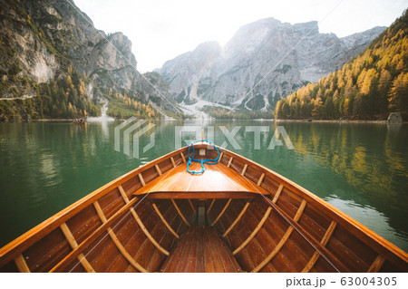 Traditional rowing boat at Lago di Braies in the Dolomites in fall Traditional rowing boat at Lago di Braies in the Dolomites in fall 63004305